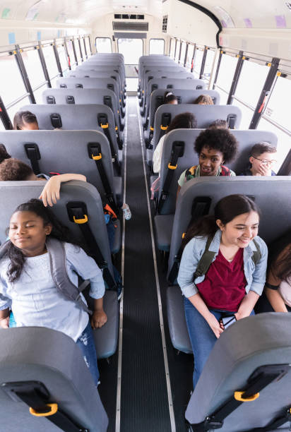 istock High angle view students seated on bus after school 1221436023
