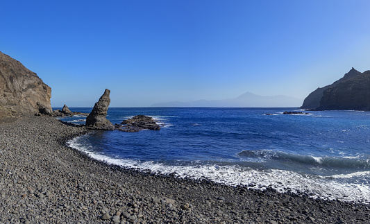 Beach Playa de La Caleta near Hermigua on the northeast coast of the island of La Gomera, Canary Islands, Spain - on the horizon the island of Tenerife