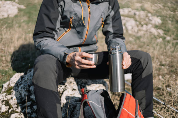 istock Close-up of male's hands holding opened thermos 1221437599