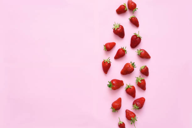 istock Strawberries on a pink background, top view. Food background. 1221438148