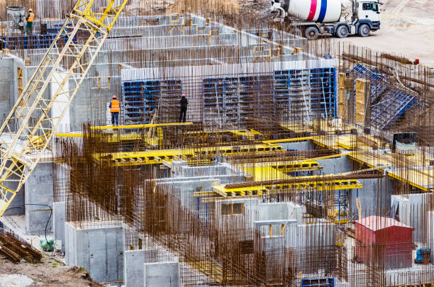 istock Construction workers install formwork and iron rebars or reinforcing bar for reinforced concrete partitions at the construction site of a large residential building. 1221439645