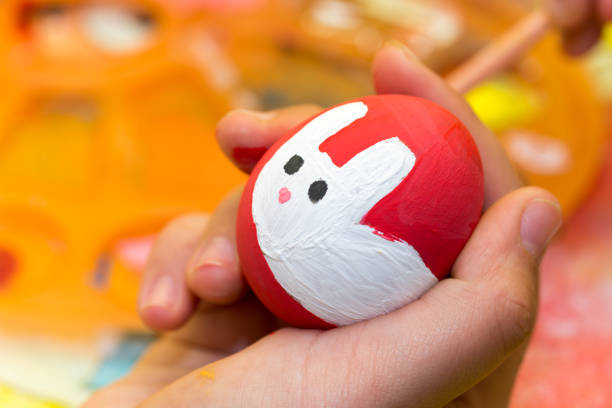 istock Kids hand holding easter egg colored with watercolors 1221441494