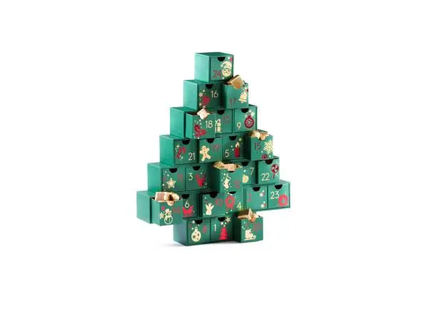 Photo of Festive calendar with gifts inside, surprise chocolates, Advent Calendar isolated Christmas tree shaped green boxes