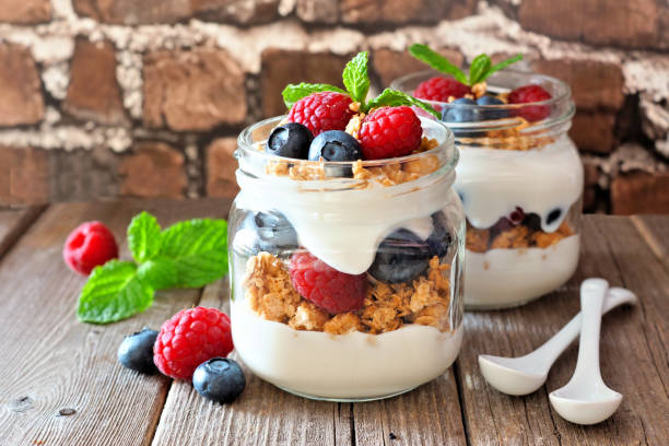 istock Blueberry and raspberry perfect in mason jars against a brick background 1221444422