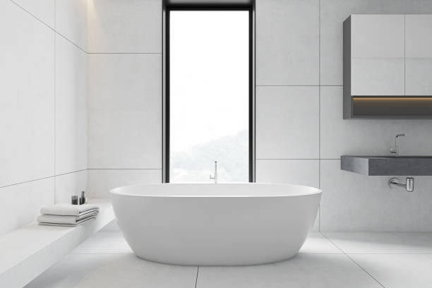 istock White tile bathroom interior, tub and sink 1221445745