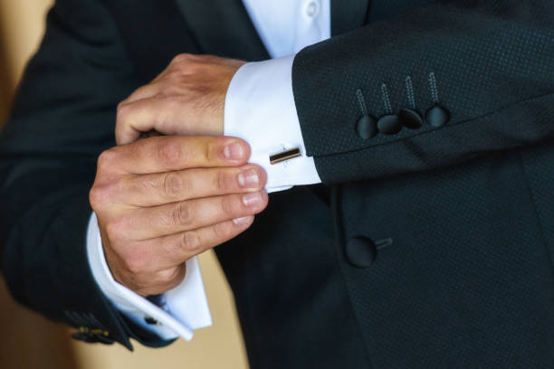 istock Businessman adjusts his white shirt button . 1221446510