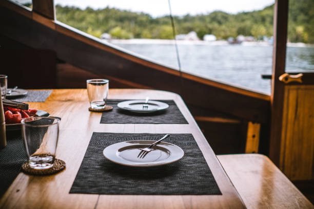 istock Place settings for breakfast on an open air table of a houseboat 1221446530