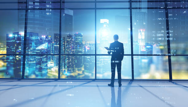 istock Business leader in panoramic office at night 1221449516