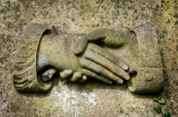 Photo of Clasped hands on a gravestone