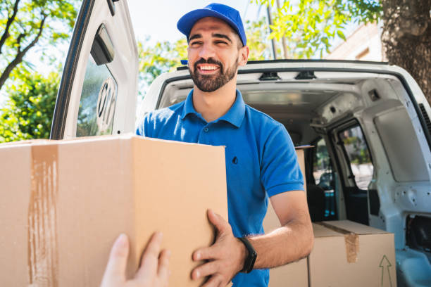 istock Delivery man carrying packages while making home delivery. 1221451117