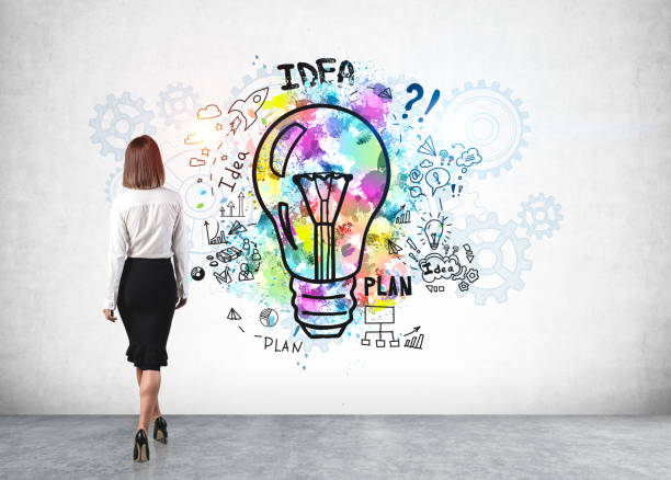 istock Young woman looking at business idea sketch 1221451243