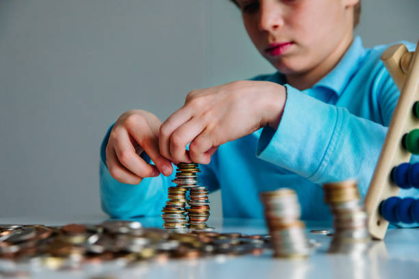 istock child counting money, boy collectiong coins, saving concept 1221452758