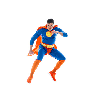 Full length of aged 30-39 years old who is tall person with black hair caucasian young male hero flying in front of white background wearing costume who is feeling joy