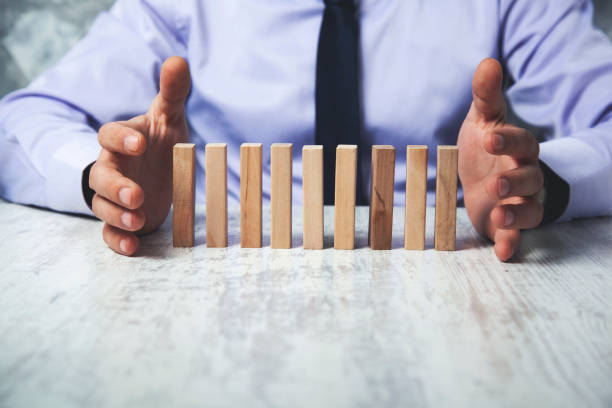istock businessman putting hands on surface with wooden cubes 1221453629