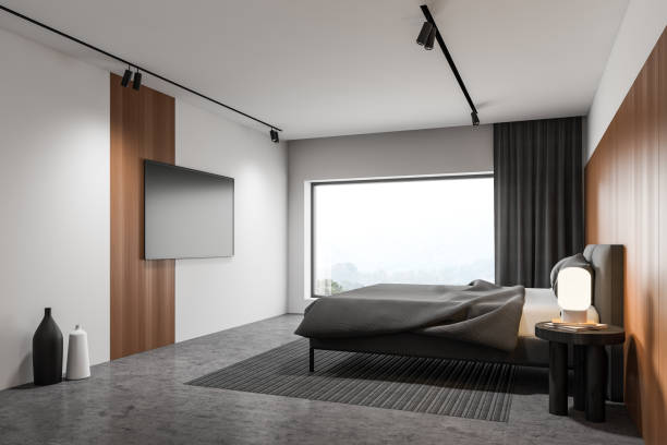 istock Panoramic white and wooden bedroom with TV 1221453704
