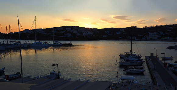 sunset above Batsi, pretty little tourist port of Andros, beautiful Cyclades islands in the heart of the Aegean Sea.