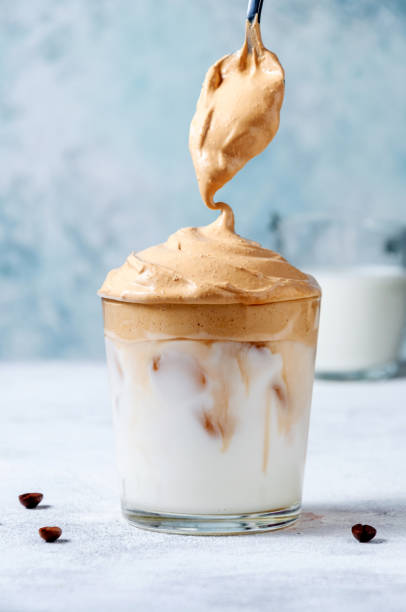 istock Iced Dalgona Coffee with Spoon on Ligrht Background. Trendy Creamy Whipped Coffee. South Korean Cold Summer Drink 1221456882
