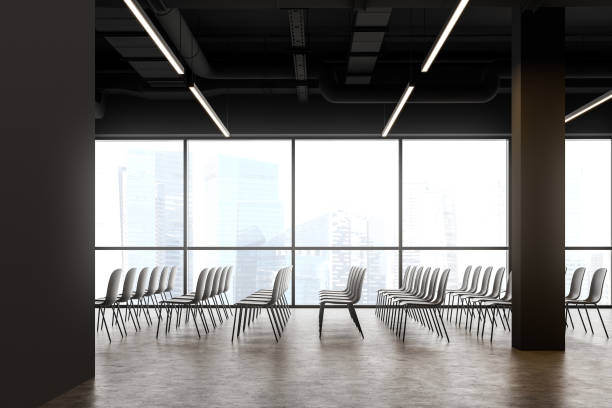 istock Rows of chairs in panoramic gray lecture room 1221457362