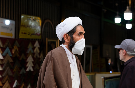 Due to the Covid-19 pandemic, Iran has faced a huge amount of coronavirus cases that have led to death. Here is Qom city where was the first place that coronavirus started spreading a mullah ( Islamic religious guy ) wearing a protective mask in the street.