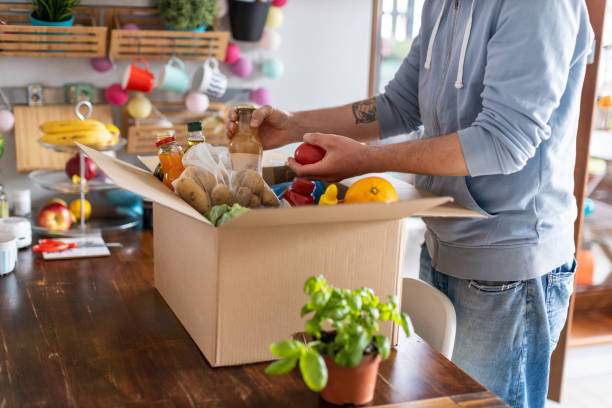 istock Man checking his fresh food delivery 1221458823