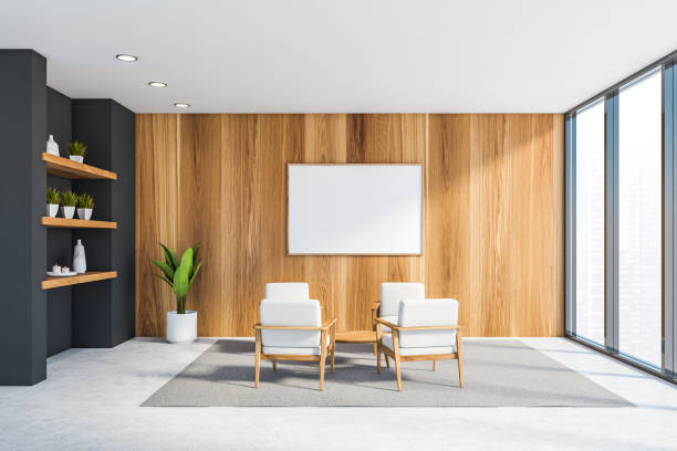 istock Wooden office lounge with armchairs and poster 1221459034