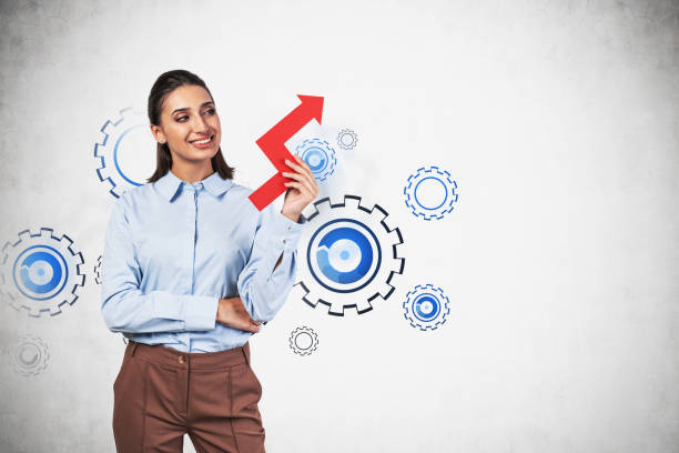 istock Smiling woman with graph, gears as team 1221459714