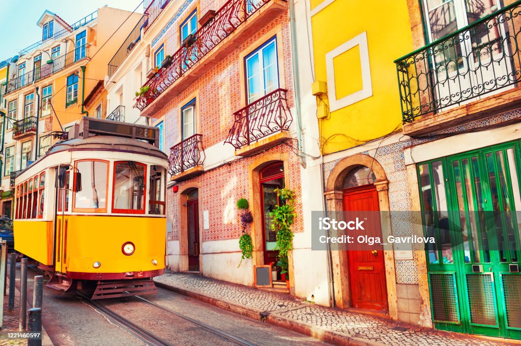 Yellow vintage tram on the street in Lisbon, Portugal. Yellow vintage tram on the street in Lisbon, Portugal. Famous travel destination Lisbon - Portugal Stock Photo