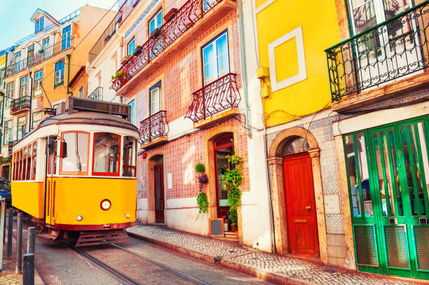 yellow vintage tram on the street in lisbon, portugal. - portugal turismo imagens e fotografias de stock