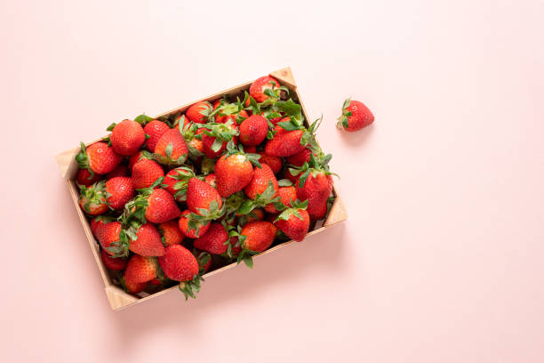 Strawberries in a wooden box top view.