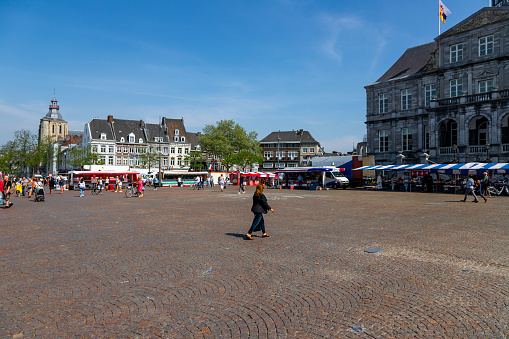 Maastricht, Netherlands 04/22/2020 Empty Market square in Maastricht with a few sellers which need to take COVID-19 pre-caution measurements when selling products. Normally this market day is crowded.