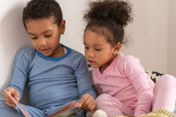 istock Brother and sister read together 1221462297