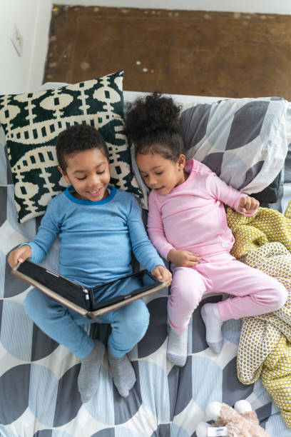 istock Overhead shot of sweet moment captured between siblings 1221462318