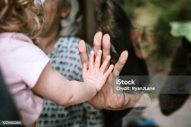 Little Girl Visits Grandparents Through Window Stock Photo - Download Image Now - Coronavirus, Senior Adult, Family
