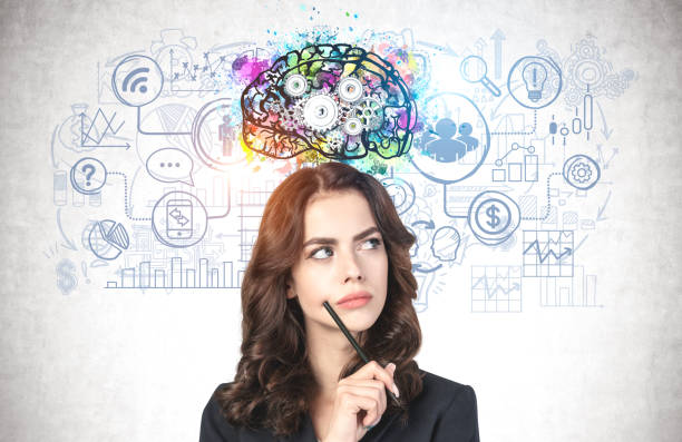 istock Young businesswoman with pen brainstorming 1221463343
