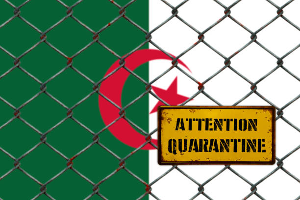 istock ATTENTION QUARANTINE ! ,Fence In Front ALGERIA FLAG 1221463861
