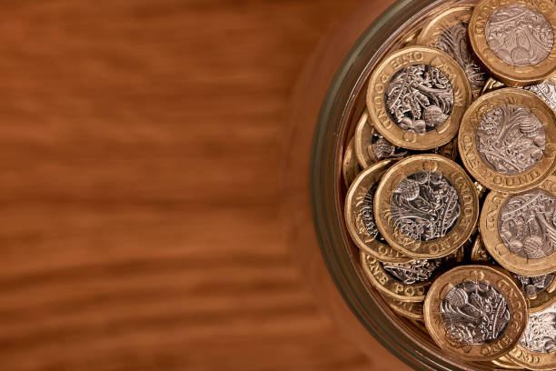 uk money in a jar on a background - coin cheap jar currency imagens e fotografias de stock