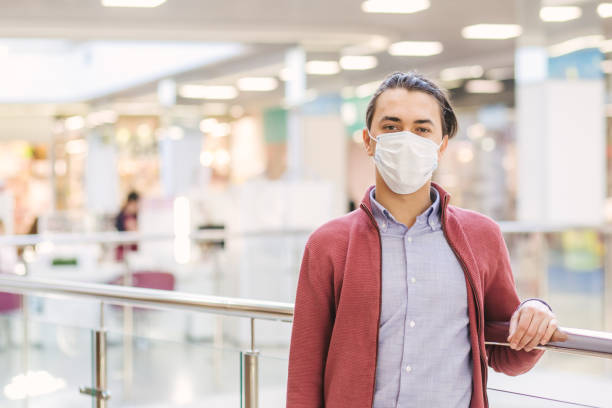 istock man in a protective mask at the Mall 1221467643