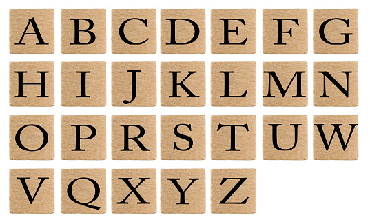 Alphabet letters on wooden tiles isolated on white background.