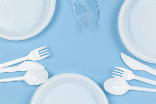 istock Disposable plastic dishes, plates, knives, forks on blue background. Frame of objects. Environmental pollution, rejection of non-recyclable plastic, Eco, zero waste concept 1221468471