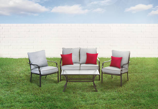 istock Patio set in a backyard with green grass and fence 1221470145