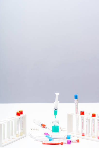Set of chemical test tubes with different colors chemicals and chemical beaker with permanganate dissolved in water, pipette, bluestone and syringe