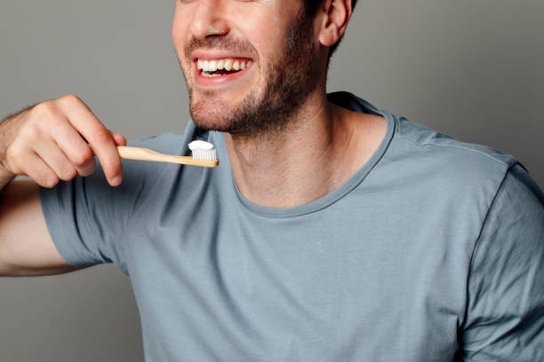 istock Dental Hygiene: Cropped Image of a Smiling Man about to Brush His Teeth 1221471780