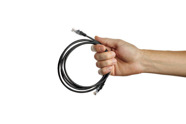 istock internet or network cable at caucasian person hand. person give cat5e cable. isolated on a white background. 1221473742