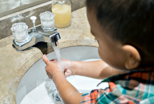 istock 5 year old boy washes his hands in the bathroom at home 1221473765