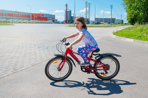 A child learns to ride a bicycle. Sport lifestyle.