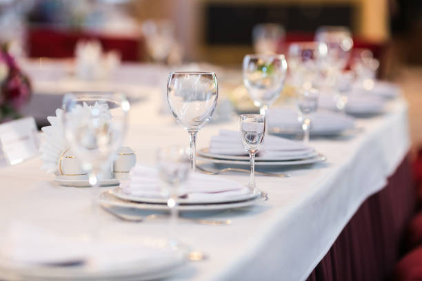 istock Table settings with white wine glasses and glasses of spirits. Wedding decor, restaurant layout 1221475268