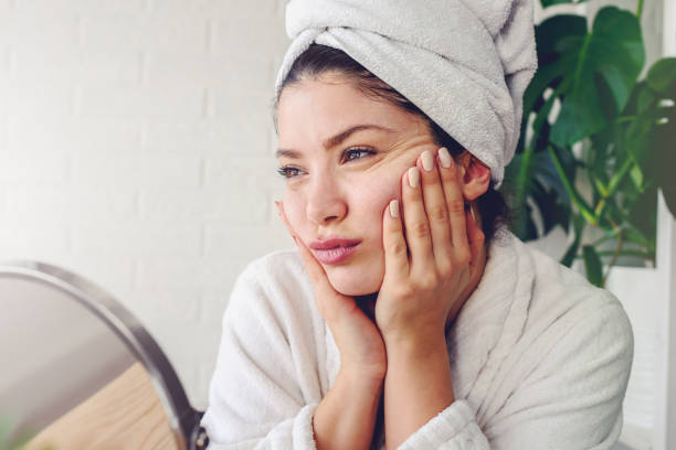 istock Young woman cleaning face with natural cosmetics 1221475932
