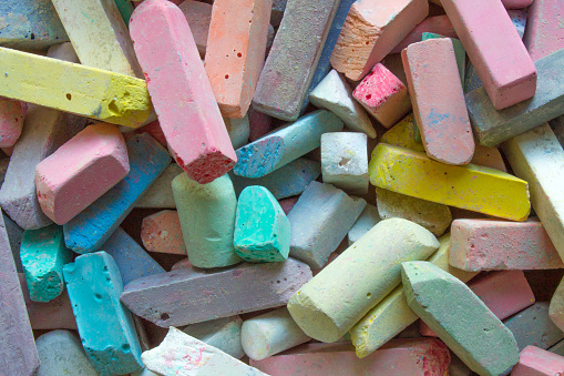 A bunch of colorful pieces of chalk close-up space to copy. Concept: children's creativity