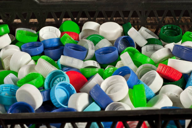 istock Many plastic jams close up. Texture of bottle caps on black background. 1221476330
