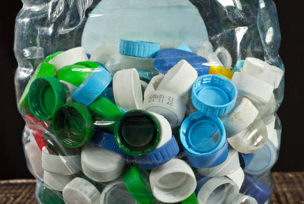 istock Many plastic jams close up. Texture of bottle caps on black background. 1221476339